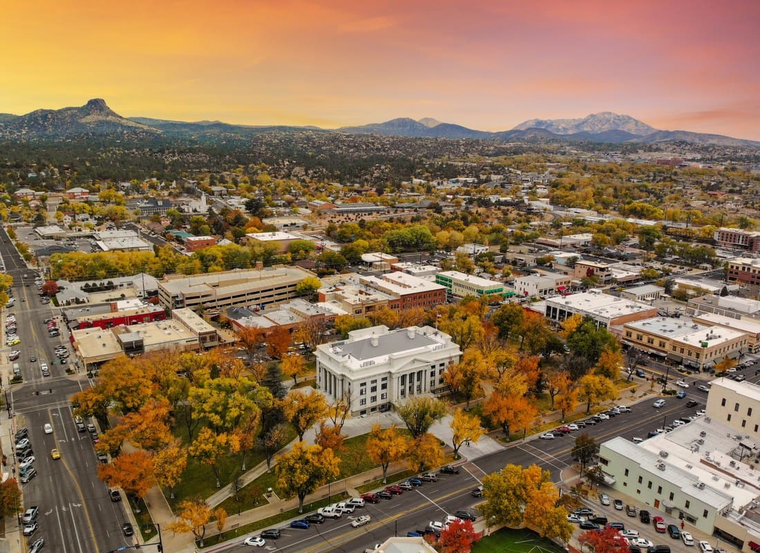 Prescott, AZ - Aerial View Of Downtown Prescott's Courthouse Plaza Surrounded By Fall Foliage At Sunset
